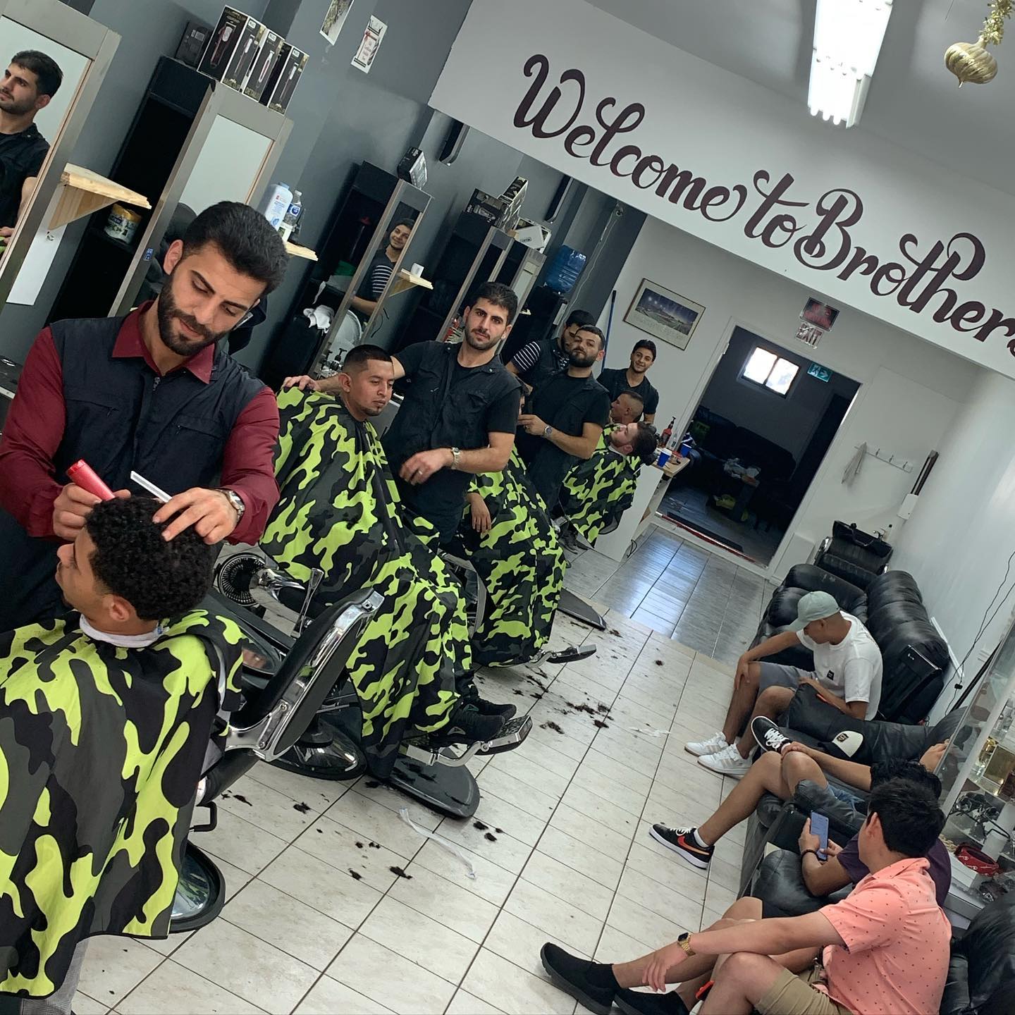 Brothers Barbershop interior and team